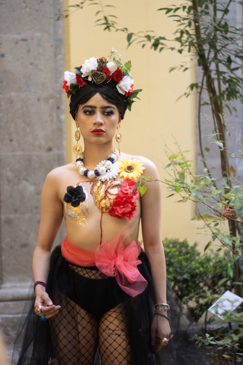 A woman in a black and white dress with flowers on her head