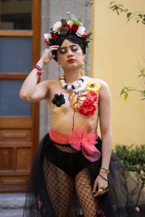 A woman in a floral dress and black fishnet stockings