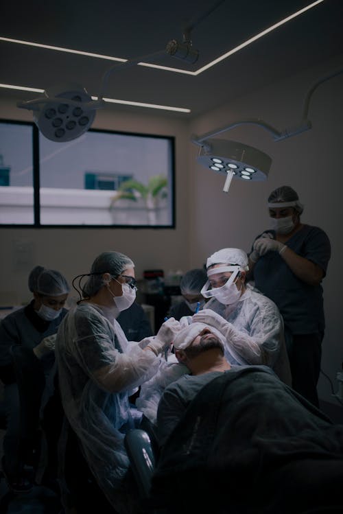 A group of people in surgical masks in a room