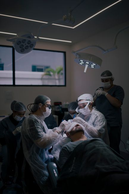 Surgeons conduct a hair transplant procedure in a modern operating room.