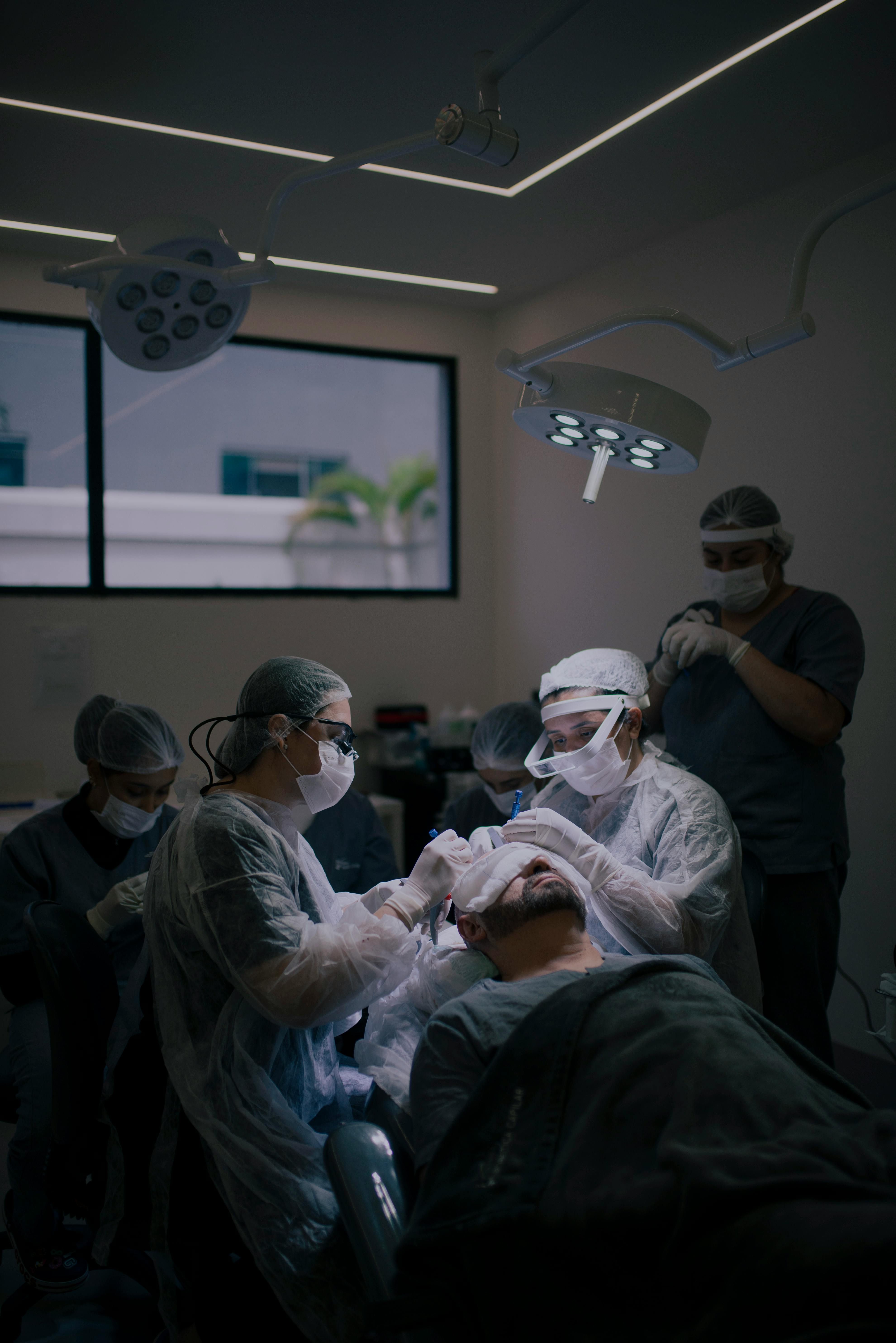 A Woman Arranging Medical Tools in an Operating Room · Free Stock Photo