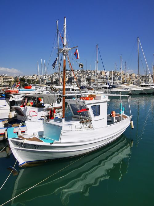 Free Explore the serene view of moored boats in Piraeus, Greece under a clear sky. Stock Photo