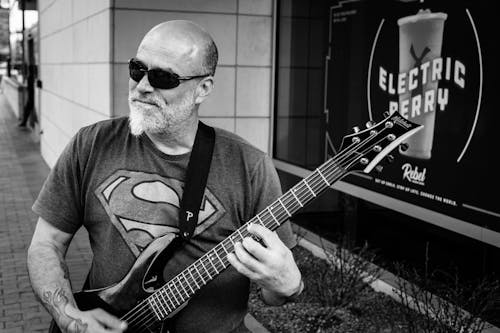 Monochrome Photo of Man Playing Electric Guitar