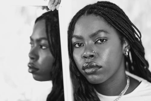 A black and white photo of a woman with dreadlocks