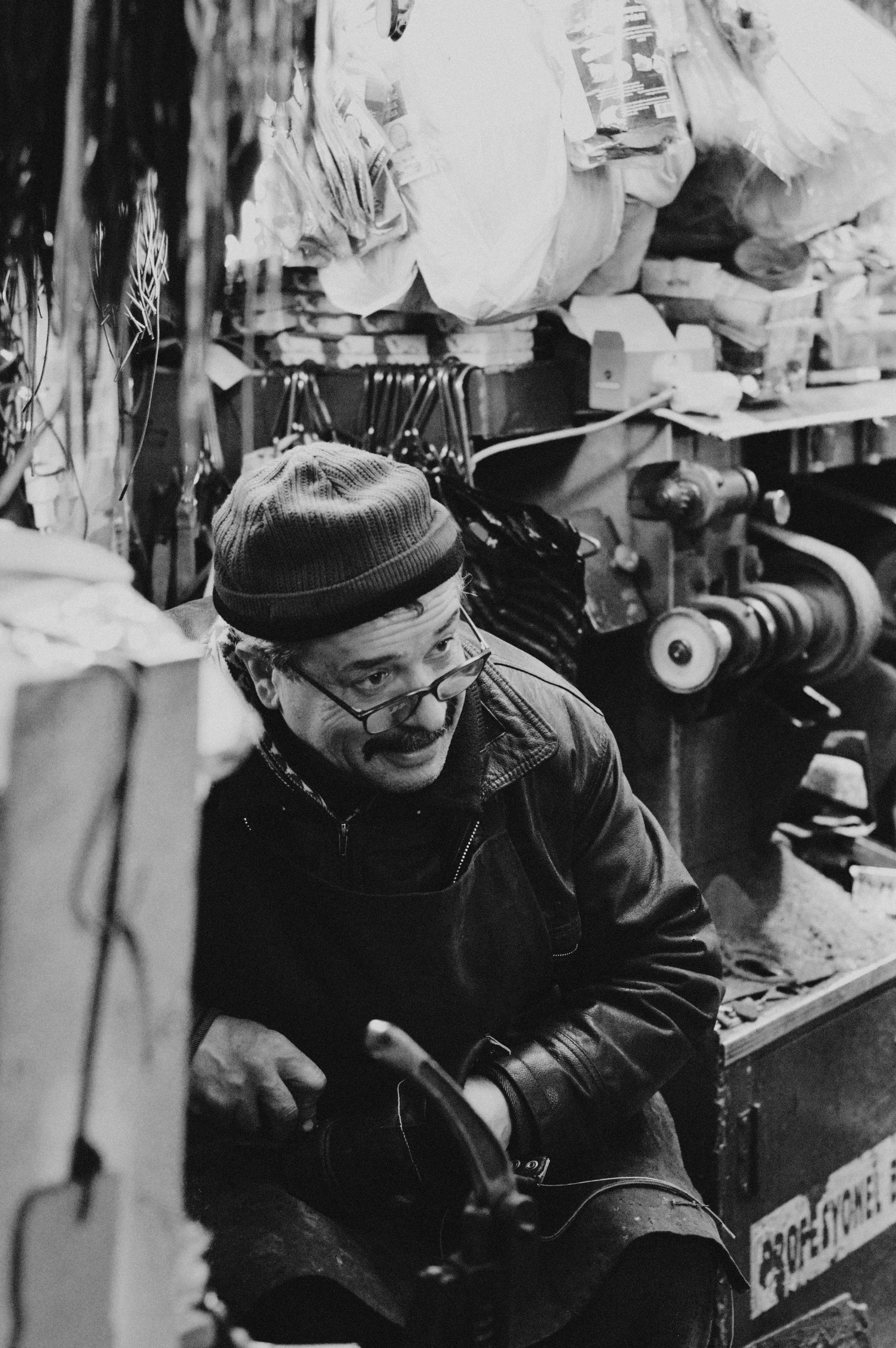 Craftsman Sitting by Machine · Free Stock Photo