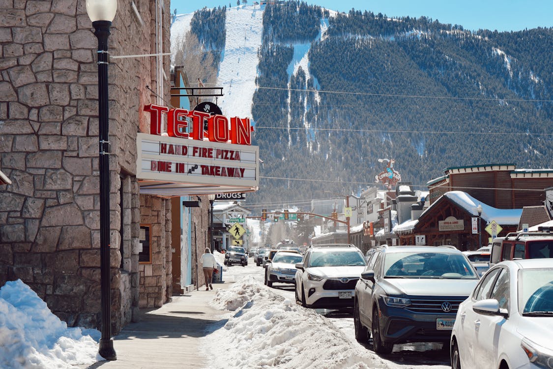 A sign for the bar in front of a mountain