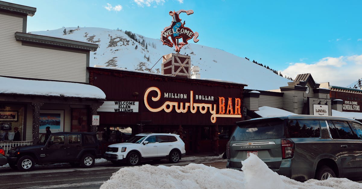 Iconic Million Dollar Cowboy Bar with snow-covered streets in Jackson, Wyoming during winter.