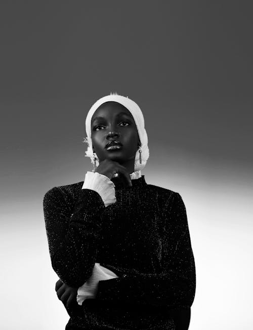 A black and white photo of a woman with a hat