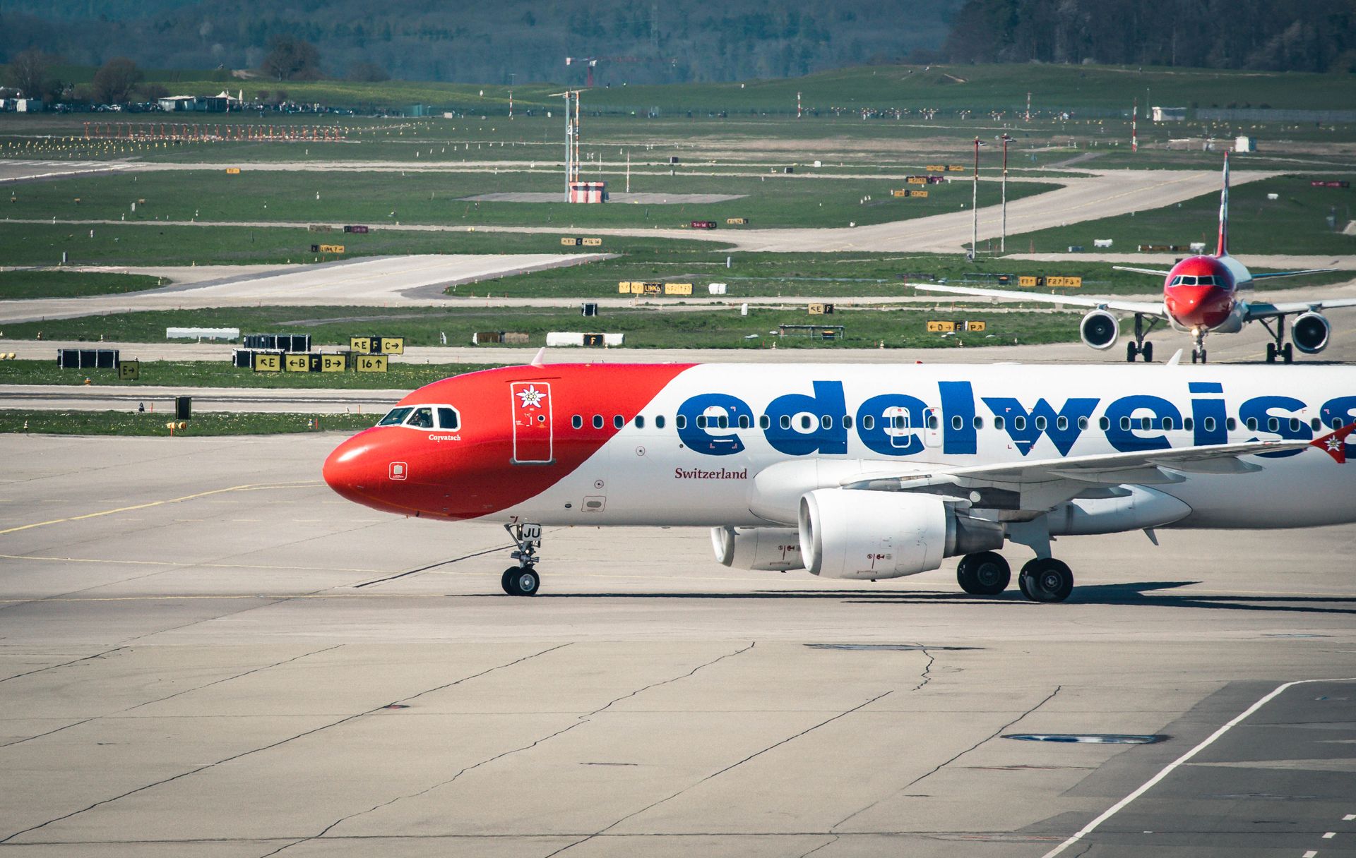 Edelweiss Air Airbus A320 on the tarmac at Zurich Airport in Switzerland, showcasing aviation and travel.