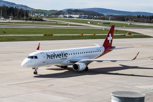 A swiss air plane is parked on the runway