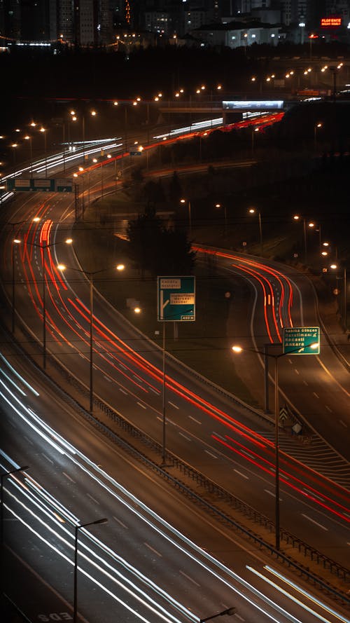 A long exposure photograph of a highway at night