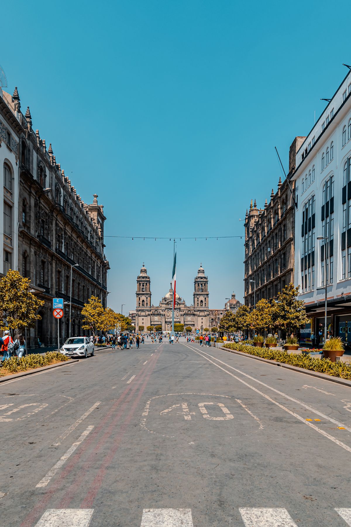 Stunning view of Metropolitan Cathedral in Mexico City on a clear day, capturing urban life and architecture.