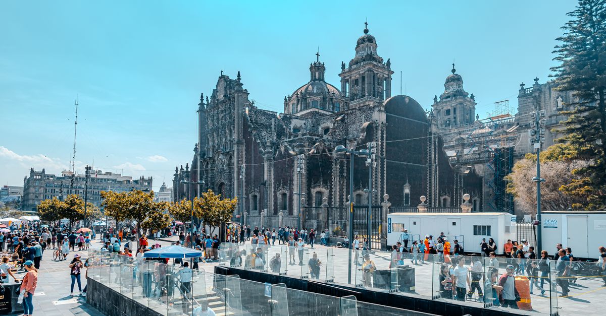 The Metropolitan Cathedral on the Zocalo in Mexico City, with people crossing the square.