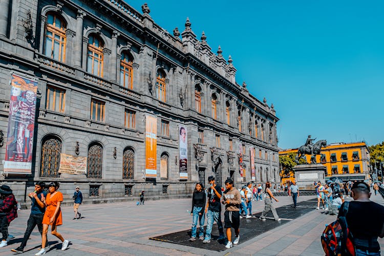 View Of Pedestrians Walking On A Pavement Near The National Art Museum In Mexico City, Mexico