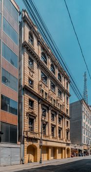 Elegant facade of an old building amidst urban streets in Mexico City, showcasing classic architecture.