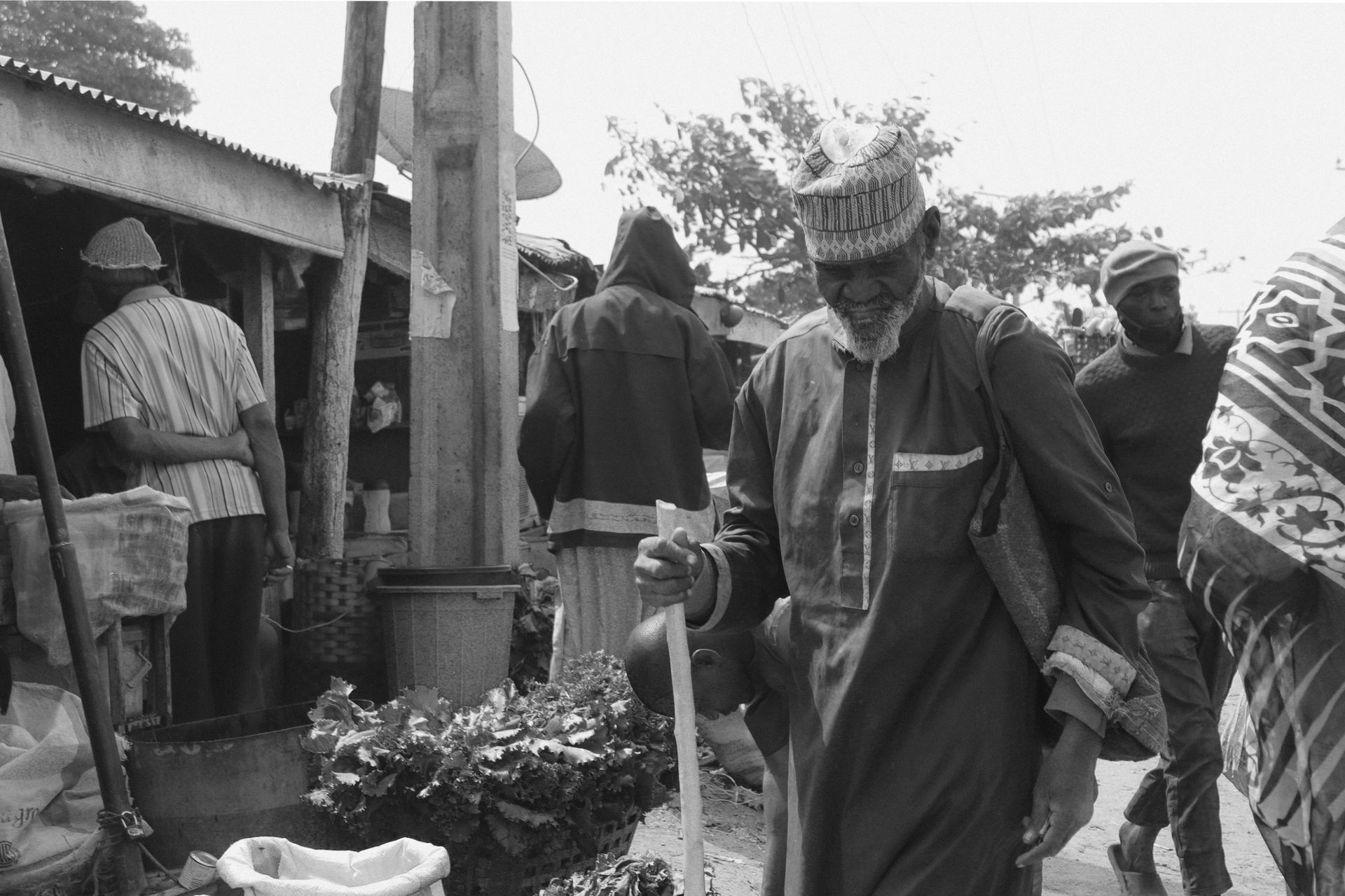 Elderly Man with a Walking Stick at the Marketplace