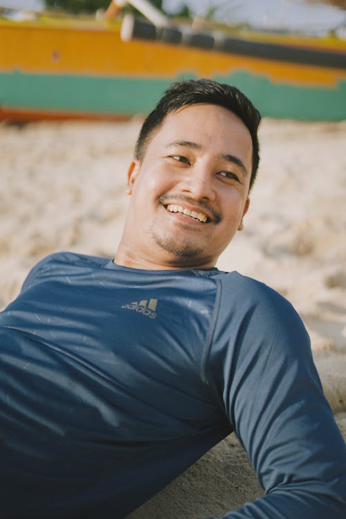 Smiling Man Lying on Beach