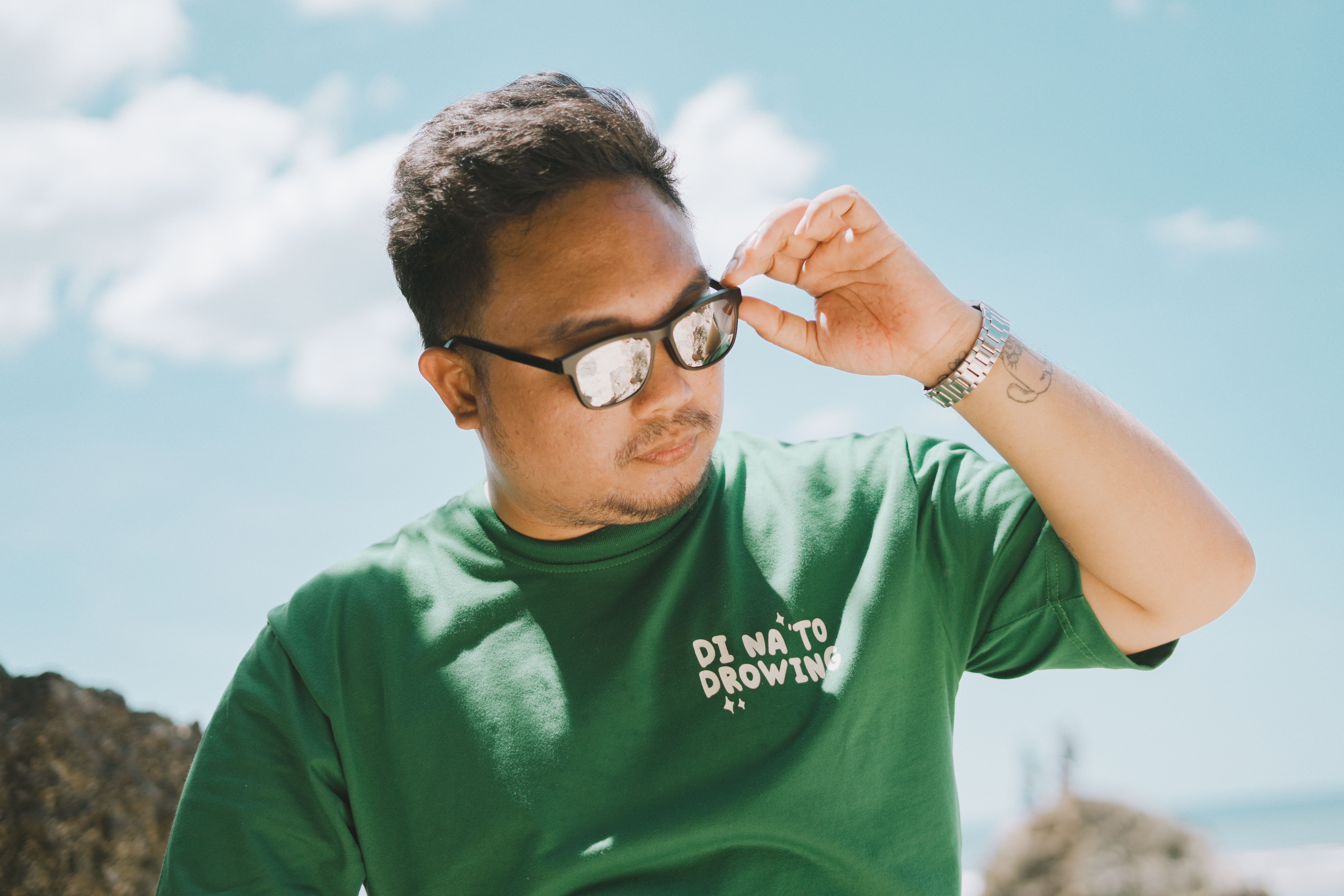 Portrait of a man in sunglasses, casually enjoying a sunny day at Bolinao Beach, Philippines.