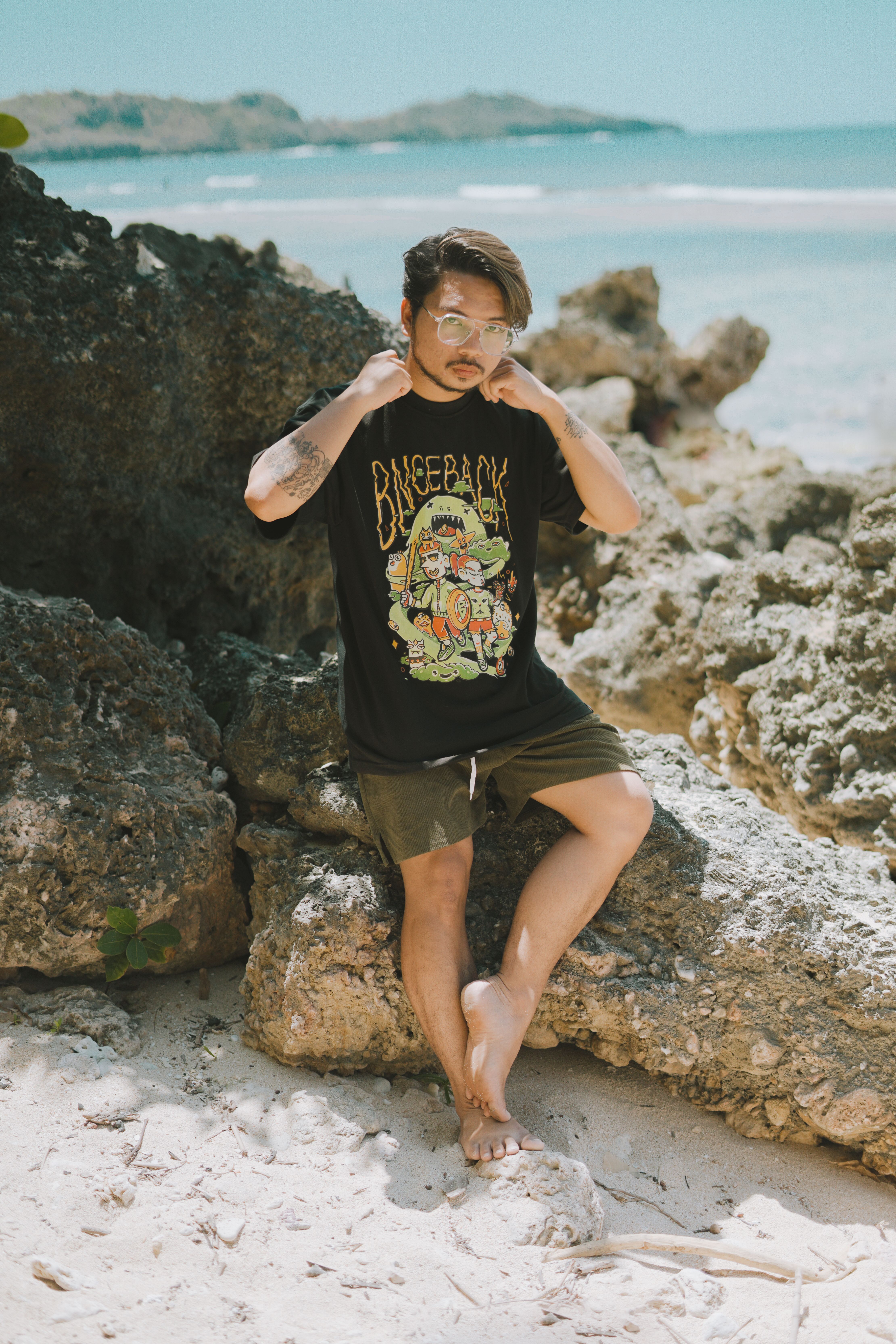 A stylish young adult man enjoying a sunny day on Bolinao beach, Philippines.