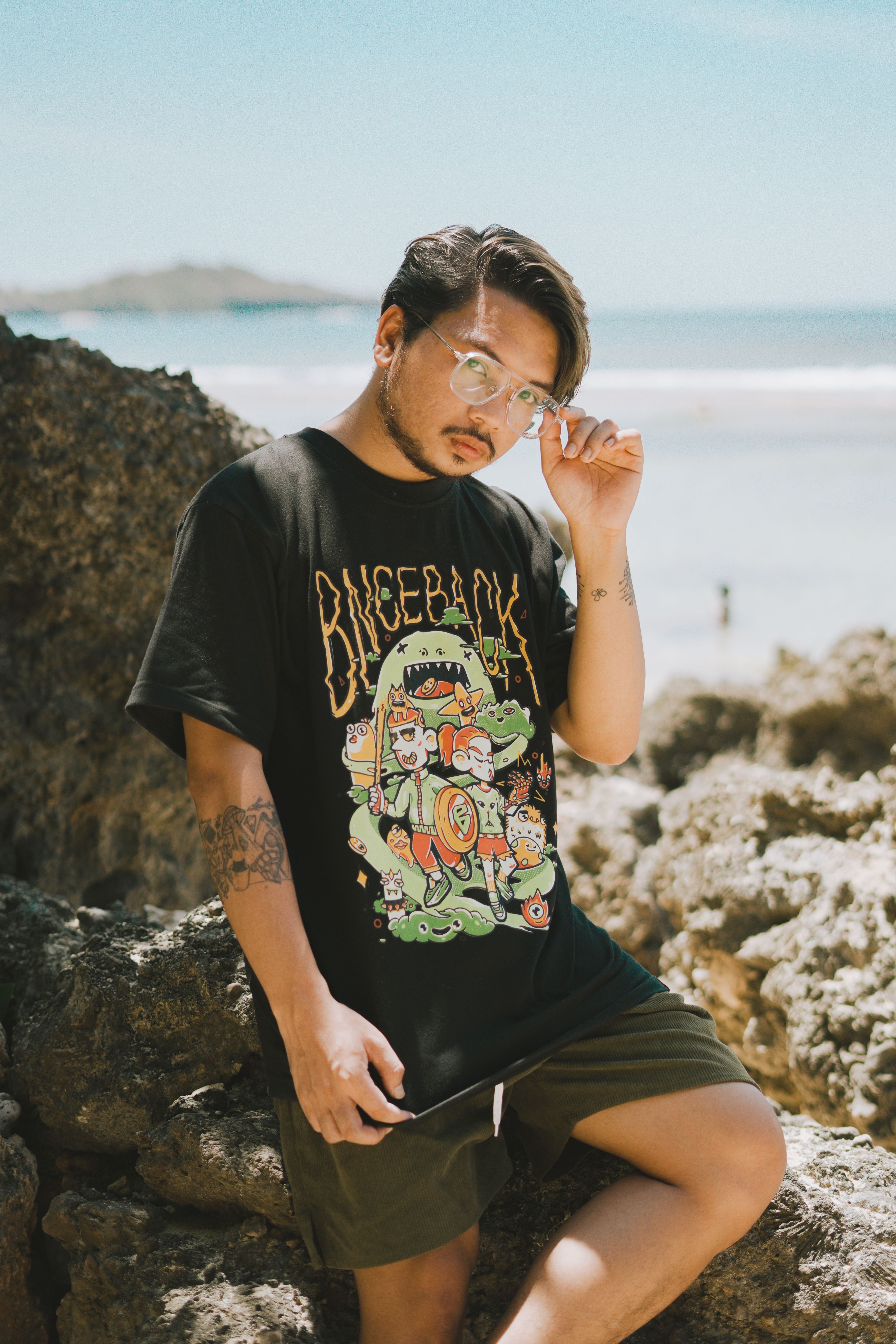 Stylish man posing in casual wear near the beach in Bolinao, Philippines.