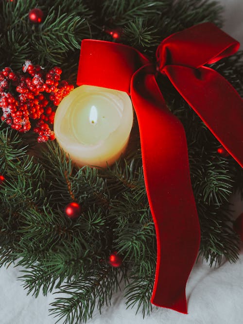 Red Ribbon and Wax Candle on Christmas Decoration