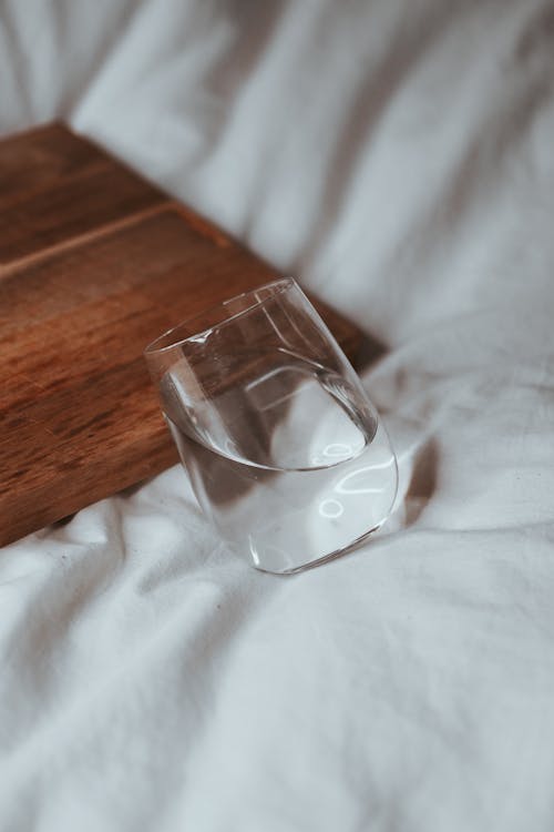 Glass of Water by Wooden Board