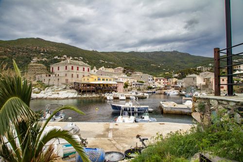 Free Picturesque view of Centuri, a coastal town in Corsica, France with boats and historic architecture. Stock Photo