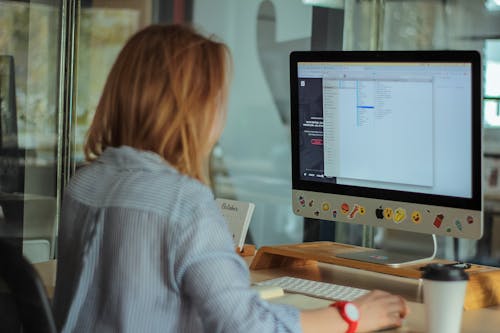 Woman Using Computer in Office