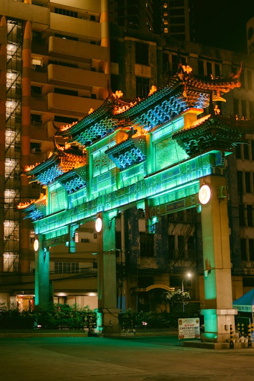 A green and blue chinese archway at night