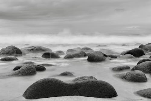 Black and white photograph of rocks on the beach