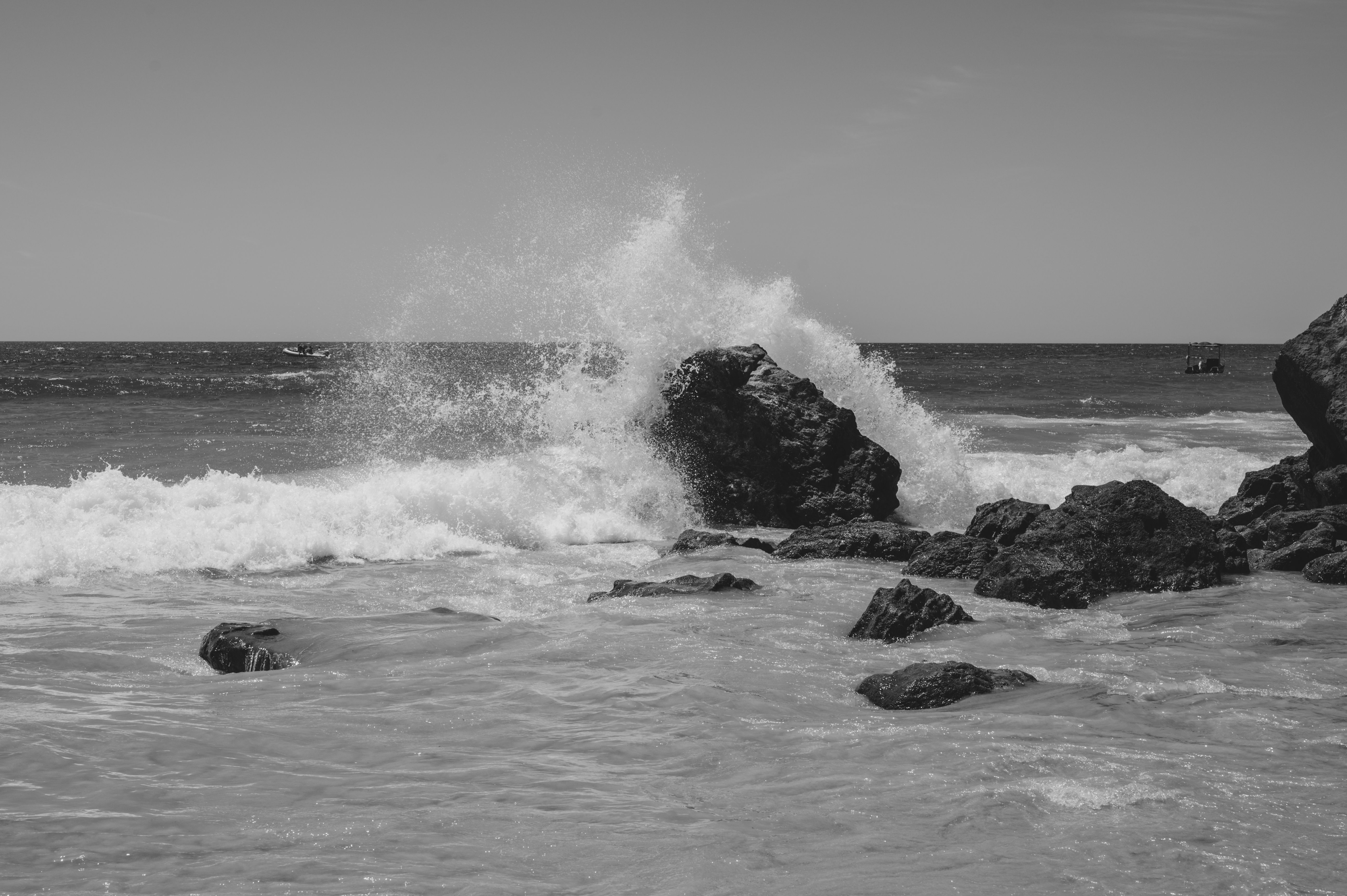 Black and White Photography of Waves Hitting Rocks · Free Stock Photo