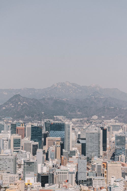 A city skyline with mountains in the background