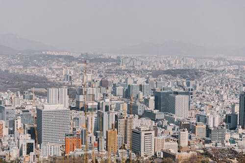 A cityscape with buildings and mountains in the background