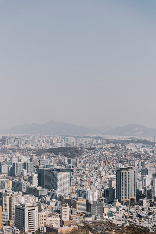 A cityscape with buildings and mountains in the background