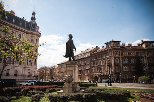 A statue of a man in a suit on a street