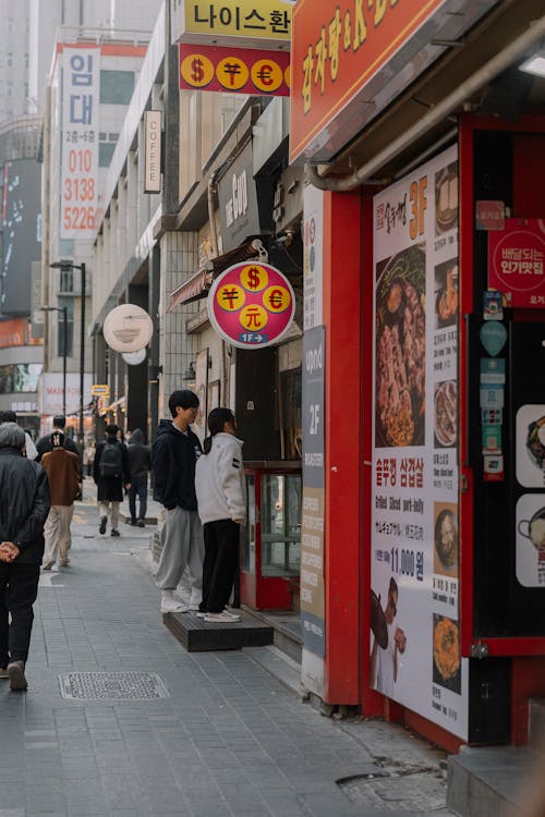 A street with people walking down it and a restaurant