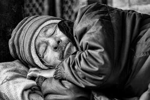 A homeless man sleeping on the street