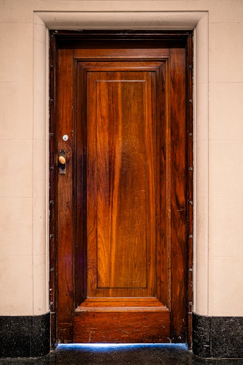 A wooden door with a light shining through it