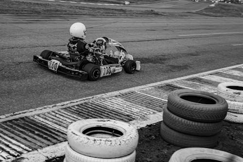 A black and white photo of a go kart racer