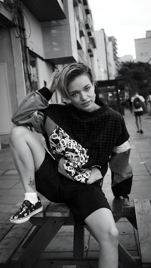 Black and White Photography of a Woman Posing on a Bench