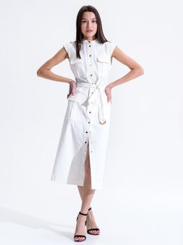 Stylish young woman in a white dress at a studio shoot indoors with a white background.
