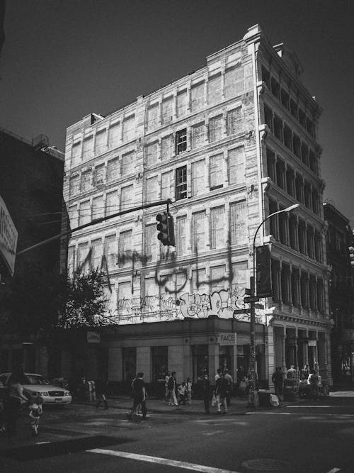 Black and white photo of a building with people walking