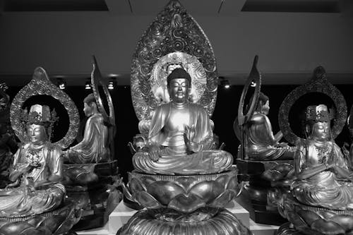 A black and white photo of buddha statues