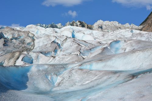 Free A stunning glacier landscape with ice formations under a blue sky. Stock Photo
