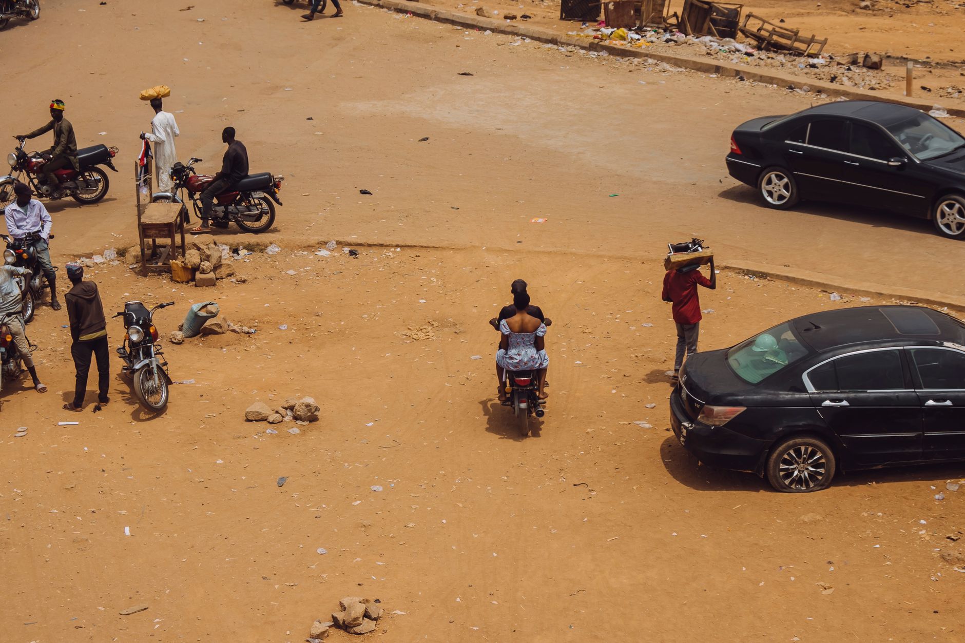 High angle view of people and motorcycles in a busy street in Abuja, Nigeria.