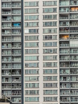 Close-up of a modern high-rise residential building facade in an urban setting.