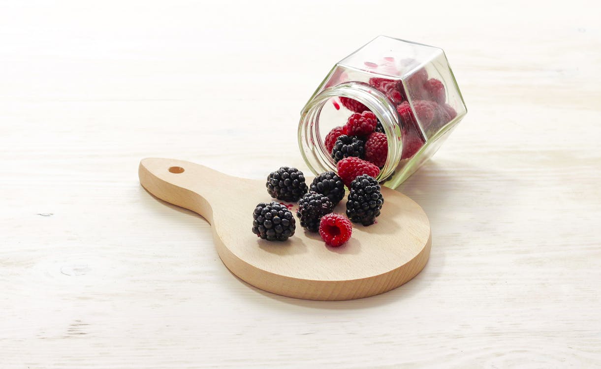 Free Clear Glass Bottle With Raspberries Inside Stock Photo