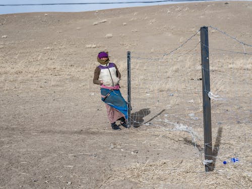 Man by the Fence in a Valley 