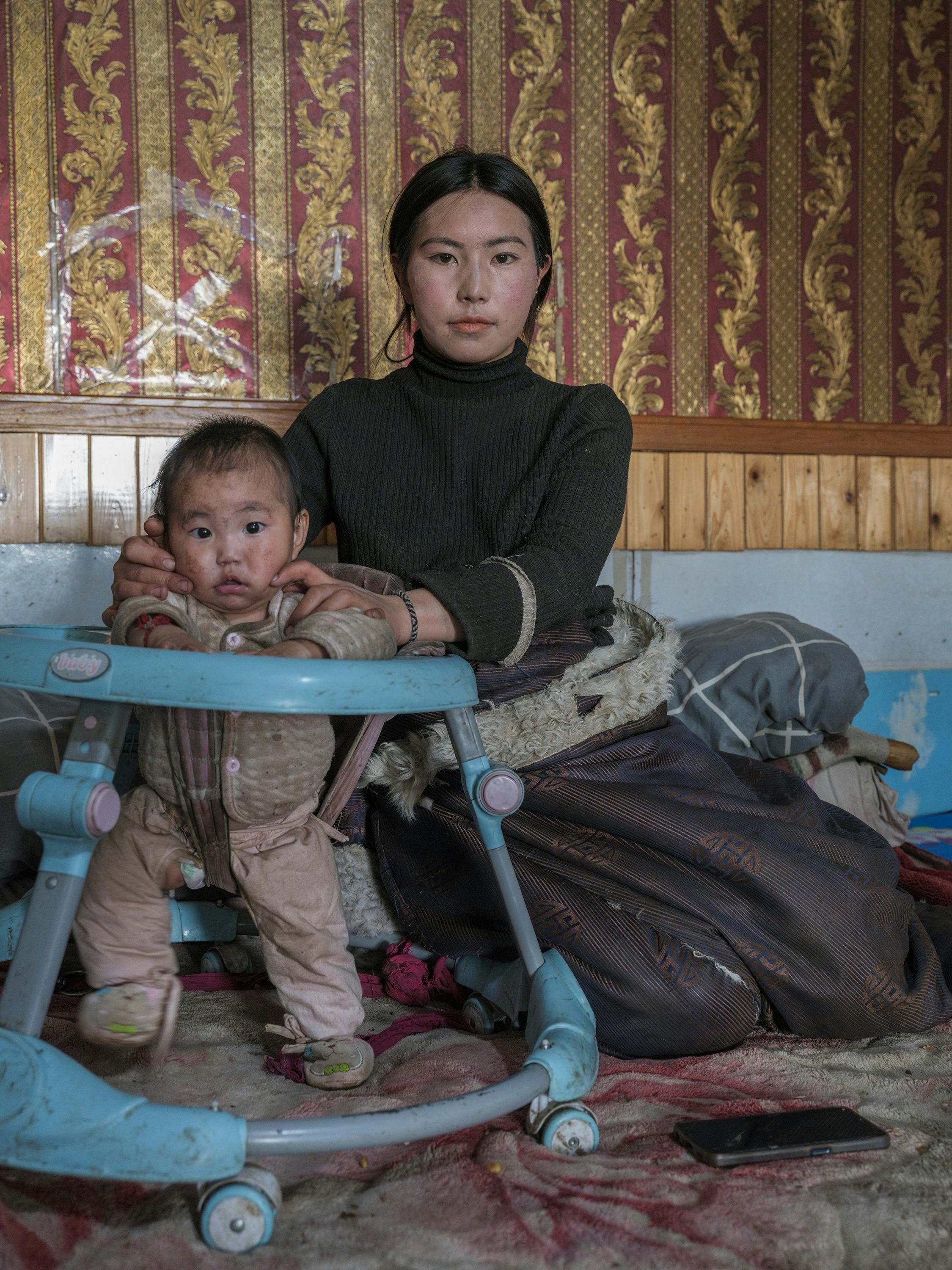 woman in traditional clothing sitting with baby