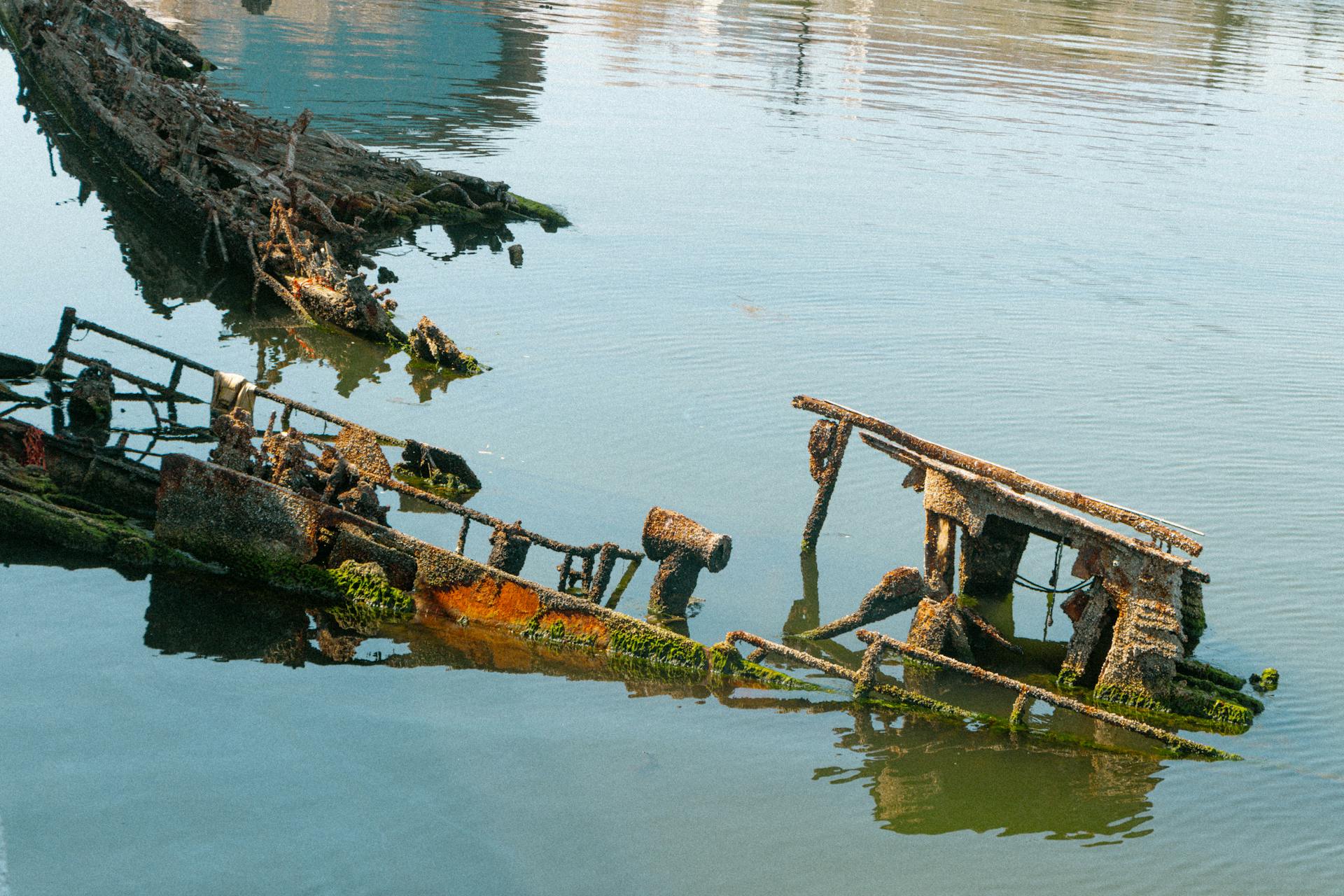 Photo of Dirty Remains of a Shipwreck on a Shore